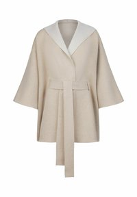 Beige omslagsrock med en bred, fiskbensmönstrad krage. Har en knytning i midjan och vida ärmar, tillverkad av mjukt tyg.