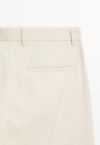 Beige cotton trousers with a smooth texture, featuring a straight cut, belt loops, and a single back pocket with a piped opening.