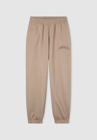 Pantaloni jogger beige con vita elastica e orli a costine. Presenta un sottile testo "KENTUCKY" in una tonalità più scura sulla coscia sinistra.