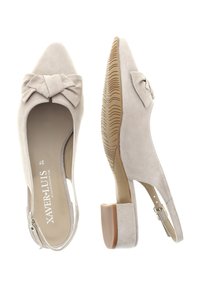 Light beige suede slingback heels with a pointed toe, bow detail on the front, and a low block heel. Textured rubber sole for grip.