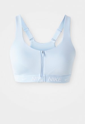 Lys blå Nike sportsbh med glidelås foran, justerbare stropper og teksturert bakside. Myk, elastisk stoff med et logo-belte.