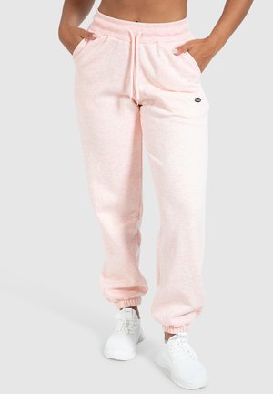 Lichtroze sweatpants gemaakt van zachte stof, met een koord in de taille, zijzakken en elastische boorden bij de enkels.