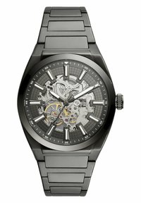 Sort metalarmbåndsur med skeleton-design, featuring en grå mønstret urskive og sølvfarvede markører, hvilket fremhæver de indviklede indre mekanismer.