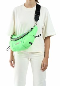 Fluo groen schoudertas met een puffy ontwerp en een getextureerde zwarte strap. Heeft metallic hardware en een gevlochten accent.