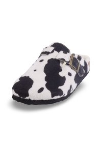 Chausson noir et blanc à motif vache, en feutre doux, avec un bout fermé, un design à enfiler et un accent décoratif en métal.