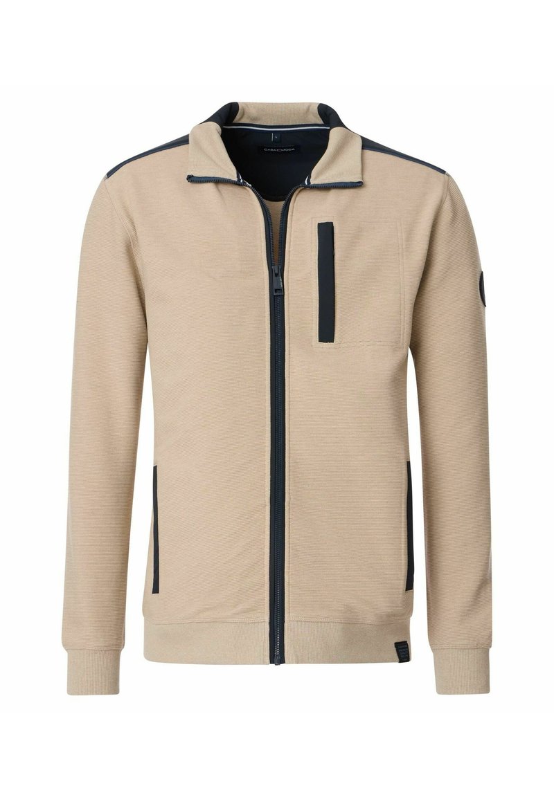 Beige zip-up jas met zwarte accenten, structuurstof, opstaande kraag, een ritsborstzak en geribbelde manchetten.