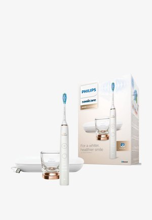 Philips Sonicare 9000 elektrische Zahnbürste in Weiß mit einem blauen Bürstenkopf, Glashalter und roségoldenen Akzenten, verpackt mit einem weißen Ladeetui.