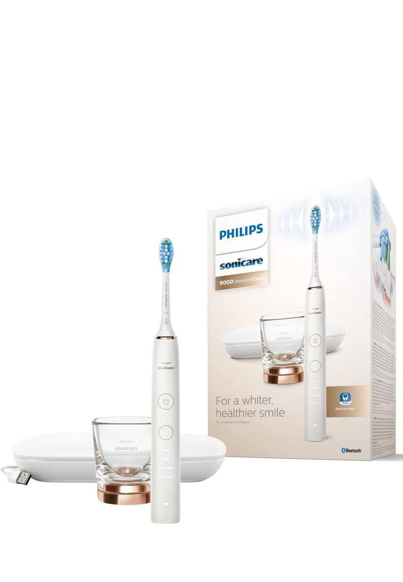 Spazzolino elettrico Philips Sonicare 9000 in bianco con testina blu, supporto in vetro e dettagli in rosa dorato, confezionato con un case di ricarica bianco.