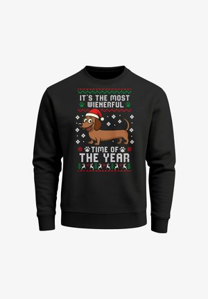 Black sweatshirt featuring an illustration of a brown dachshund in a Santa hat. Text in white and green reads “It’s the most Wienerful time of the year.”