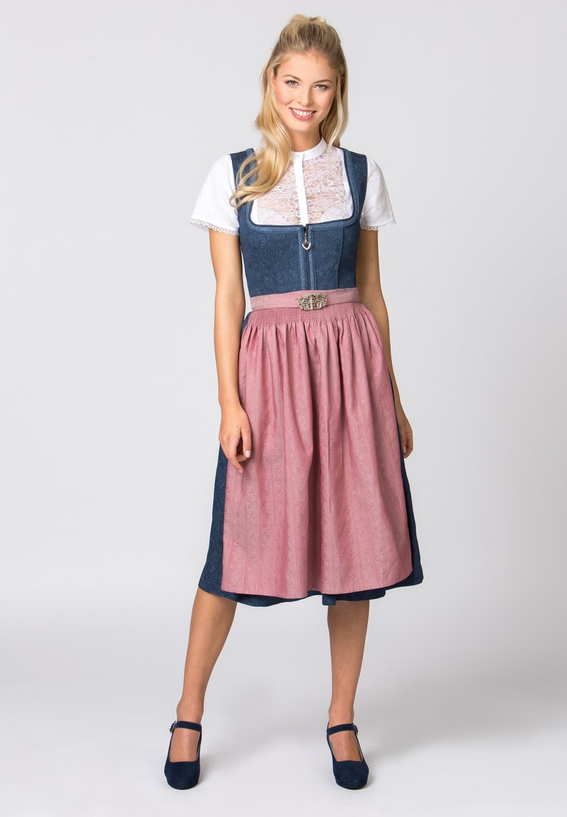 Traditionelle bayerische Tracht besteht aus einem dunkelblauen Mieder, einer weißen Spitzenbluse und einem rosa Rock mit einem gemusterten Design, akzentuiert durch eine silberne Gürtelbuckle.