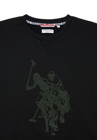 Černé bavlněné tričko s grafikou zeleného polo hráče. Design zahrnuje dva jezdce na koních, přičemž postavy mají detailní provedení.