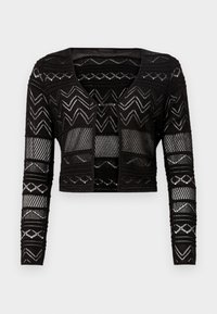 Czarny krótki kardigan z wzorem zygzakowym, ażurową strukturą i długimi rękawami. Posiada dekolt w serek i zapięcie na guziki.
