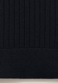 Close-up of black ribbed knit fabric with vertical and horizontal knit patterns.