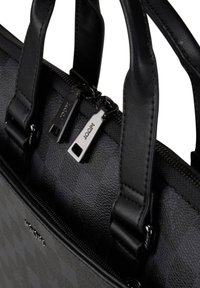 Black leather handbag with textured surface, dual zippers, and structured handles. Features subtle logo detail and geometric pattern.
