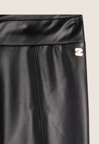 Zwarte nepleer leggings met een gladde textuur, voorzien van een brede tailleband en een klein metallic logo accent.