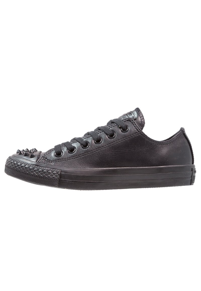 Black leather sneaker with a low profile, round toe, and spiked accents on the toe cap. Features six pairs of eyelets and a textured sole.