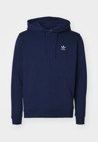 Mörkblå bomullshoodie med en stor framficka, snörhuva och en liten vit logotyp på bröstet. Slät textur och ribbade manschetter.