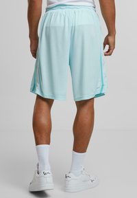 Karl Kani SIGNATURE TAPE - Tracksuit bottoms - lightaqua