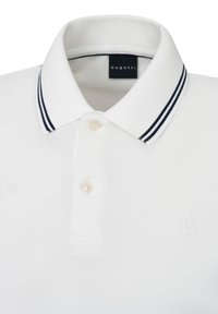 White polo shirt with a textured fabric, two-button placket, and a navy-striped collar. Features a subtle embroidered logo on the chest.