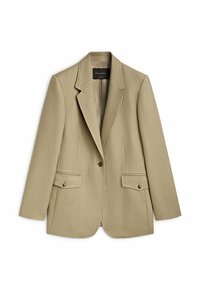 Blazer beige su misura con chiusura a un bottone, rever a bicorne, due tasche frontali e una leggera texture nel tessuto.