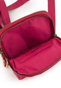 Rød crossbody taske med lynlåslukning, glat tekstur og en indvendig lomme med flad design til organisering.