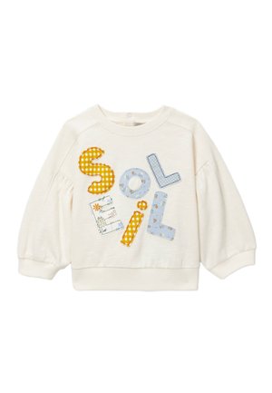Sweat-shirt crème à manches longues pour tout-petits, avec manches bouffantes et lettres colorées en patch épelant "SOELIL" à l'avant.