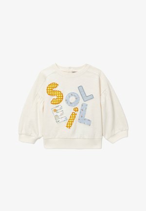 Sweat-shirt crème à manches longues pour tout-petits, avec manches bouffantes et lettres colorées en patch épelant "SOELIL" à l'avant.