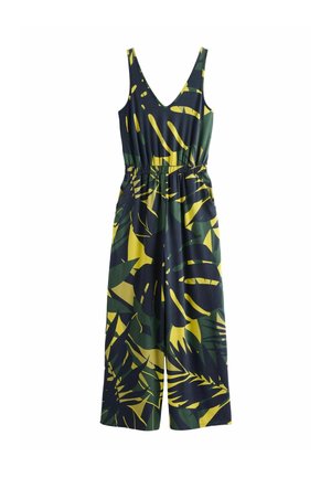 Combinaison sans manches avec un profond décolleté en V et des jambes larges, ornée d'un motif de feuilles tropicales vertes et jaunes sur un fond sombre.