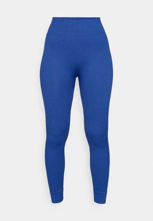 Leggings azuis de aparecimento canelado com uma cintura alta, textura suave e forma ajustada. Comprimento até ao tornozelo sem padrões visíveis ou detalhes de hardware.