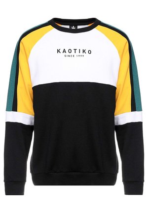 Sort, hvid, gul og grøn sweatshirt med farveblokke og "KAOTIKO SINCE 1999" trykt midt på fronten.