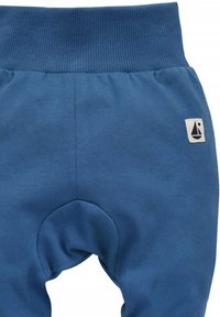 Blauwe katoenen broek met een geribde tailleband, voorzien van een design met kniepatch en een klein wit zeilschip-logo aan de zijkant.