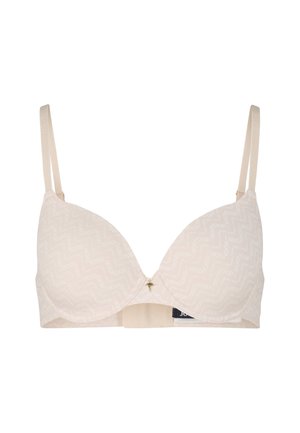 Nude bh met gladde, gewatteerde cups die een subtiel zigzagpatroon hebben, verstelbare bandjes en een kleine gouden accent aan de voorkant.