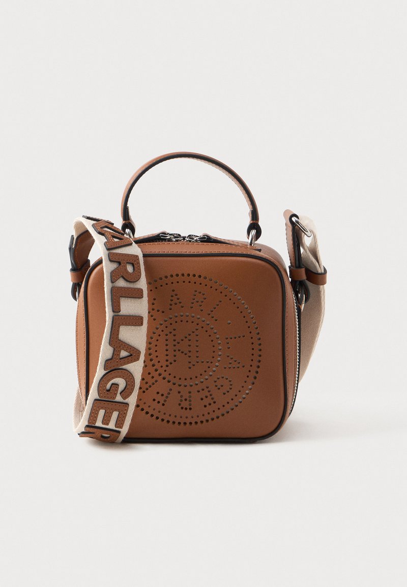 Brown leather square bag with perforated logo design, top handle, and detachable strap featuring "KARL LAGERFELD" in bold on a fabric accent.