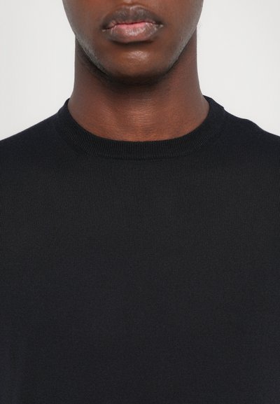 Black, ribbed knit crewneck sweater with a smooth texture. Close-up view emphasizes the neckline and fabric details.