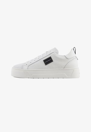 Sneakers bianchi con pattern a rilievo in croco, tomaia sintetica liscia, suola piatta e un logo nero accento sul lato.
