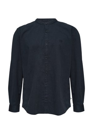 Tumed sinine nööbiga pluus, mandariinikaelusega, pikkade varrukatega ja veidi kõverate servadega. Valmistatud pehmest, tekstuurilisest kangast.