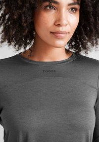 Gray long-sleeve shirt with a smooth texture and a round neckline, featuring subtle seams and a TOG24 logo printed on the front.