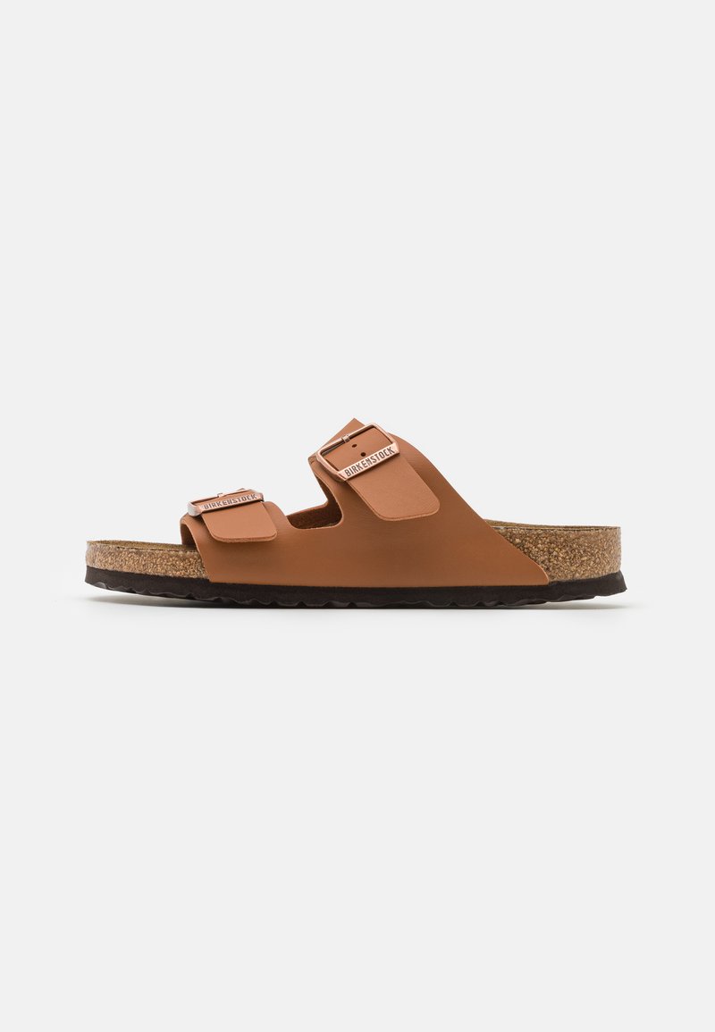 Brown sandals with two adjustable straps, made of durable material, featuring a cork footbed, rubber sole, and a textured finish.