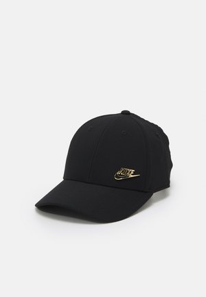Black baseball cap with a curved brim and a small gold Nike logo on the front panel, set against a plain light background.
