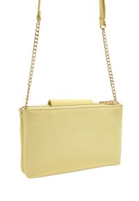 Żółta skórzana torebka na ramię o gładkiej teksturze, z łańcuszkowym paskiem i zamkiem błyskawicznym na górze, minimalistyczny design.