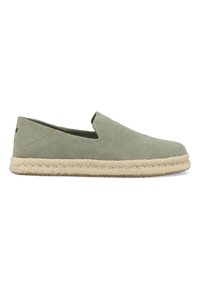 Green suede slip-on shoes with a rounded toe, rubber sole, and jute rope detailing around the base. Minimalist design with no visible hardware.
