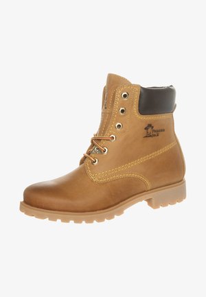 Brown leather ankle boots with a smooth texture, padded ankle, metal eyelets, and a cleated rubber sole. Features branding on the side.