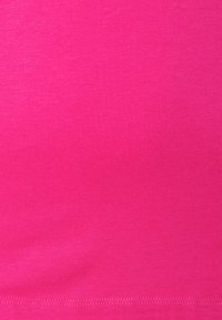 Fitted, stretchy fabric in a vibrant magenta color, with a smooth texture and subtle sheen, featuring a fine stitched hem along the bottom.