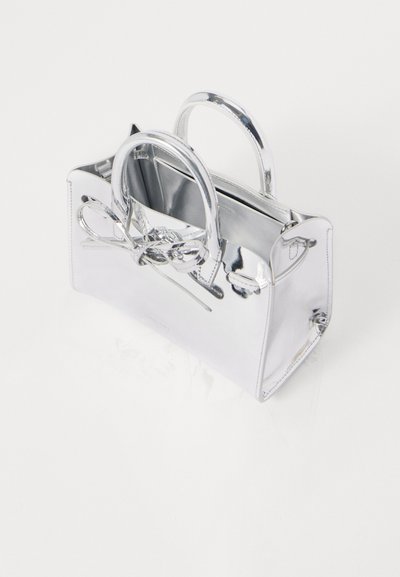 Silver handbag made of shiny material, featuring two rounded handles, a decorative bow detail, and a rectangular shape.