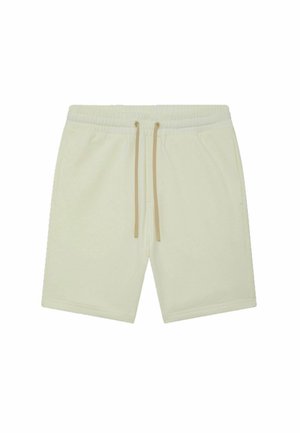 Shorts de sport couleur crème en tissu doux, dotés d'une taille élastique et de cordons beiges. Conçus avec des poches latérales.