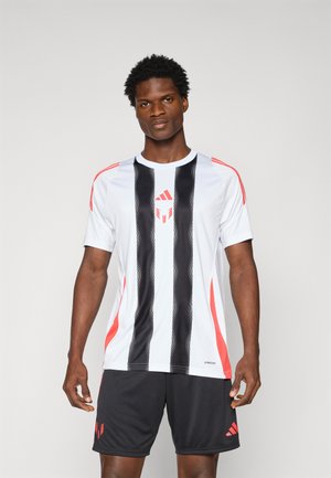 White athletic jersey with black vertical stripes and red accents. Black shorts with a red logo. Smooth, lightweight fabric, short sleeves.