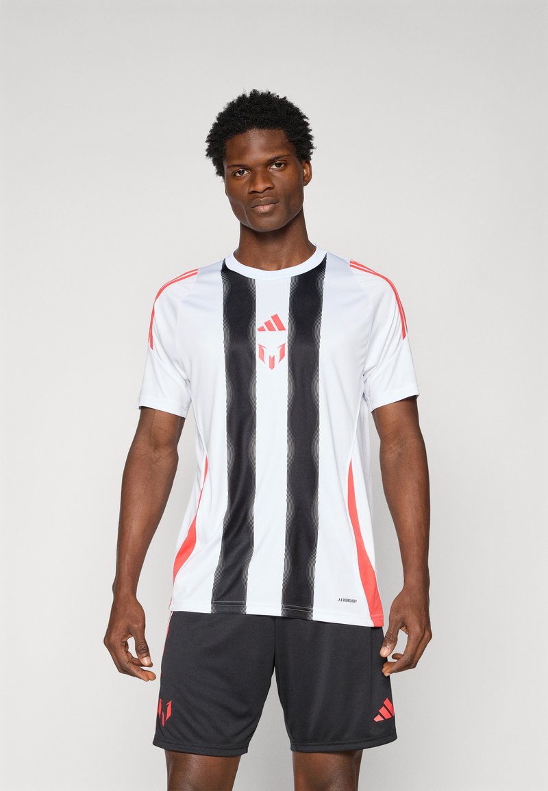 White athletic jersey with black vertical stripes and red accents. Black shorts with a red logo. Smooth, lightweight fabric, short sleeves.