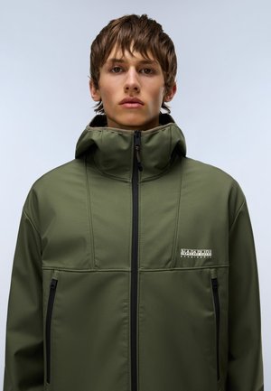 Olive green jacket with a high collar and zip closure. Features black zippered pockets and a logo patch on the chest. Smooth, matte texture.