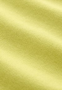 Light yellow knitted fabric with a smooth texture, featuring a fine ribbed pattern and consistent weave throughout the surface.