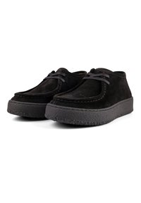 Black suede shoes with a rounded toe, lace-up design, and textured rubber sole. Features visible stitching along the edge.